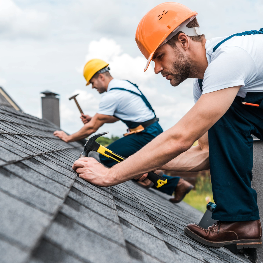 two men fixing a roof