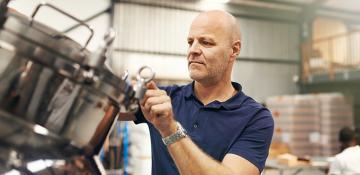 Man looking at equipment in a brewery