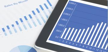 A tablet showing financial charts and data