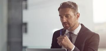 Man in suit looking at laptop