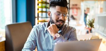 man looking at the laptop screen 